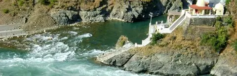 Rushing river beside a riverside temple