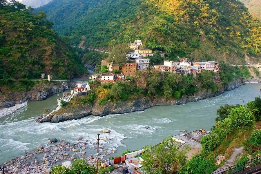Rushing river beside a riverside temple