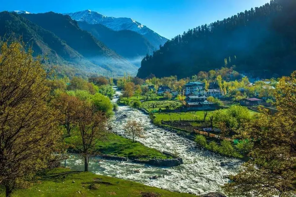 River running through a green valley in Pahalgam