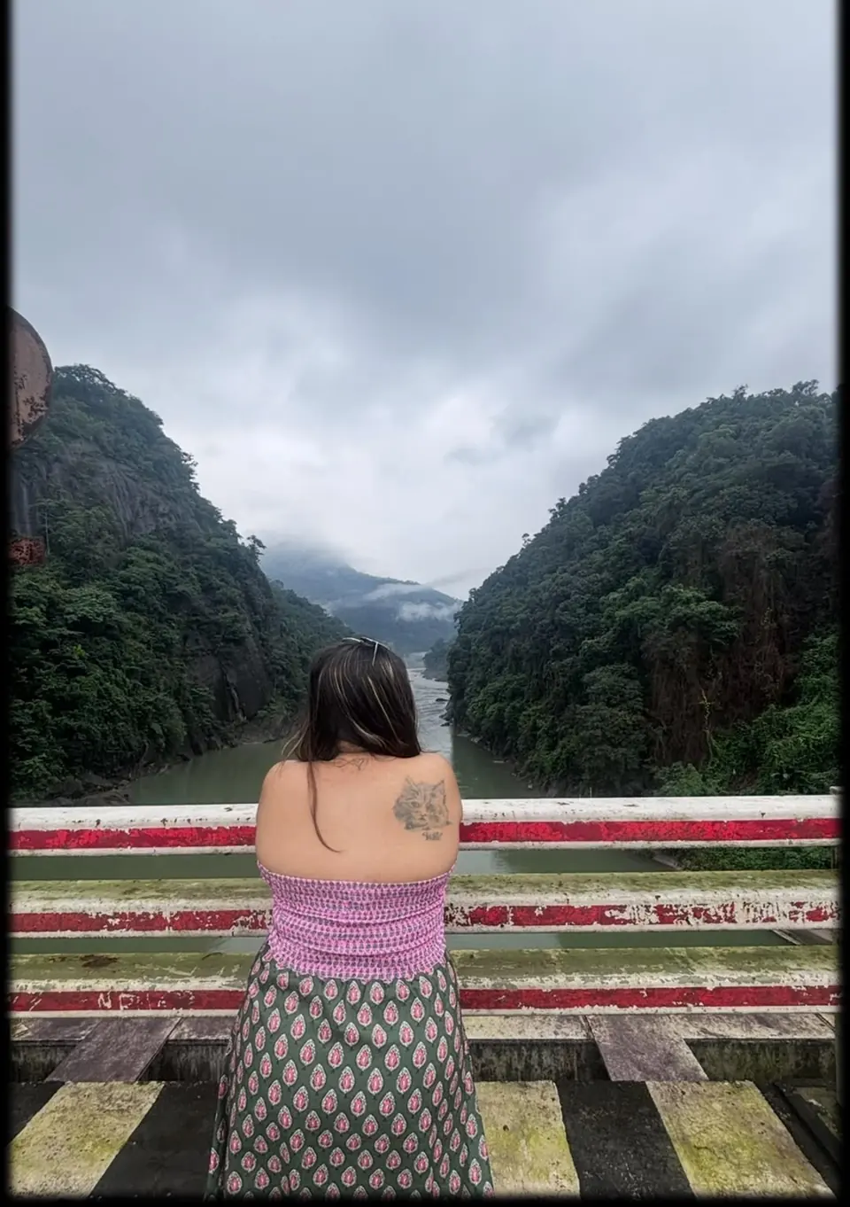 Traveller looking out over a misty Meghalaya valley